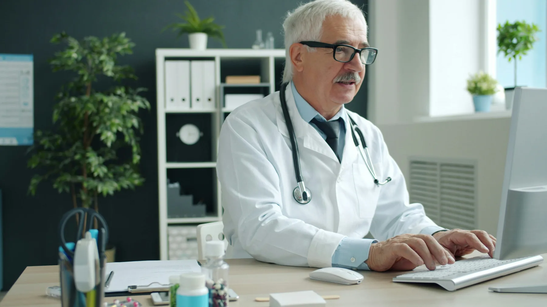 Healthcare professional working at a computer
